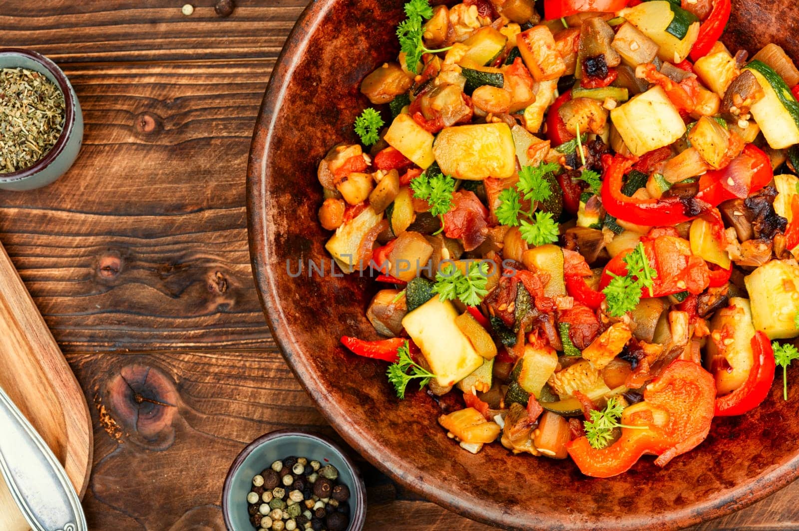 French vegetable dish, ratatouille. Baked eggplants, zucchini, peppers and tomatoes.