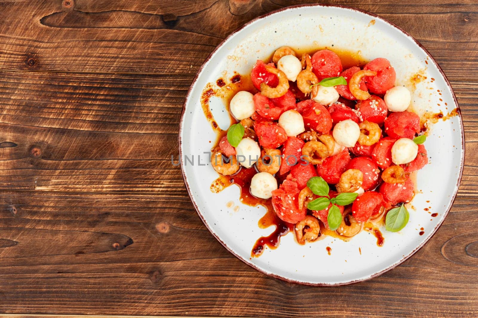 Fresh salad with watermelon, mozzarella cheese and shrimp.