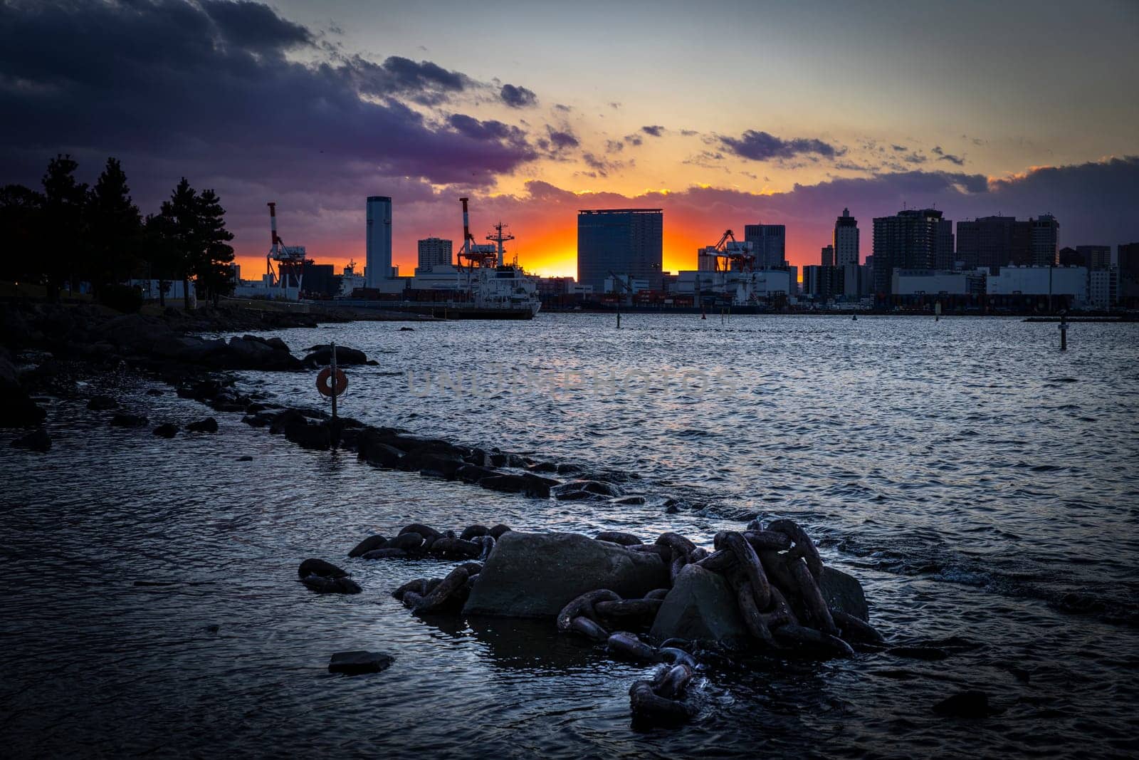 Odaiba, japan cityscape sunset  water and rusty chains tokyo