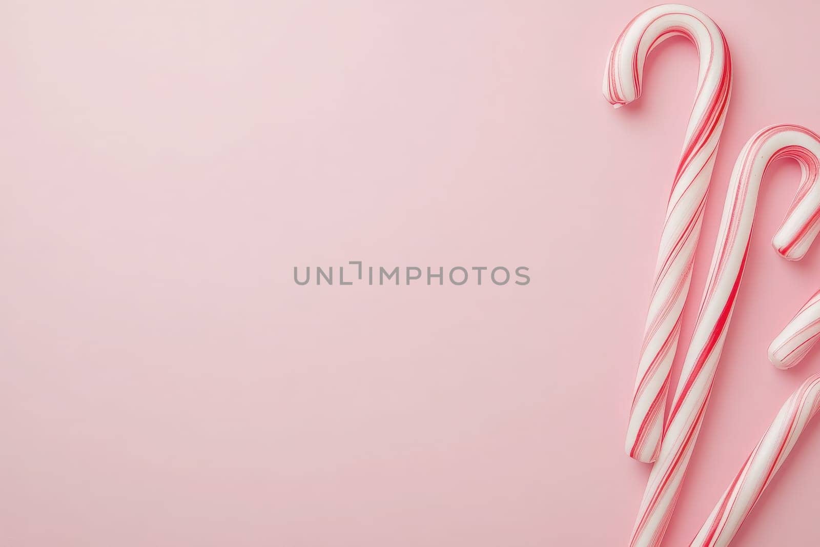 Festively colored candy canes rest elegantly on a smooth pastel background, embodying the spirit of the holiday season. Their vibrant red and white stripes add a cheerful touch to any decor.