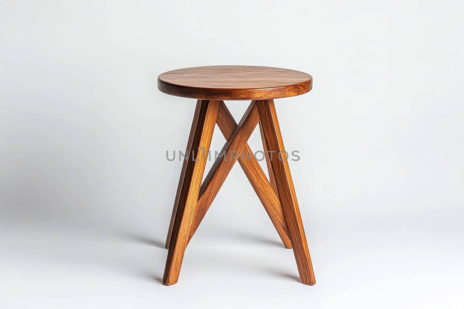 This chic side table showcases a simple yet elegant design with a round wooden top and crossed legs. It stands alone in the center, highlighting its versatility and modern appeal.