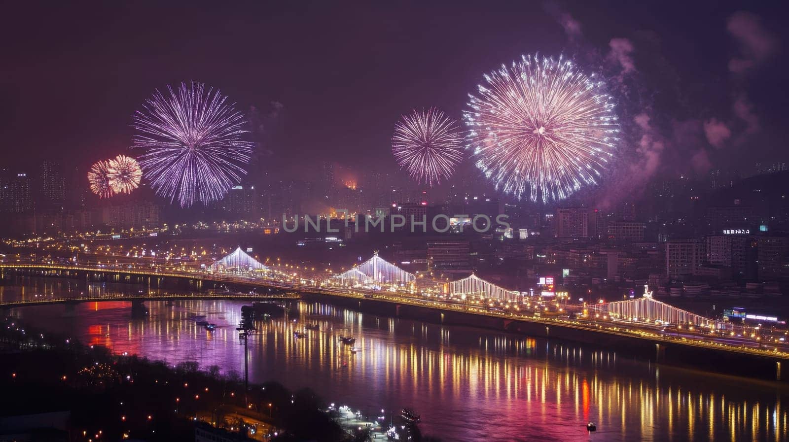 Colorful fireworks burst in the night sky over a city skyline reflecting beautifully on the river below.