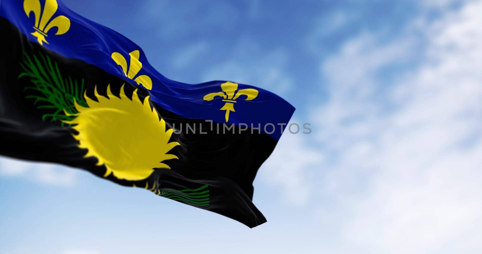 Guadeloupe flag waving in the wind on a clear day. Overseas department and region of France. 3d illustration render. Rippling fabric. Selective focus
