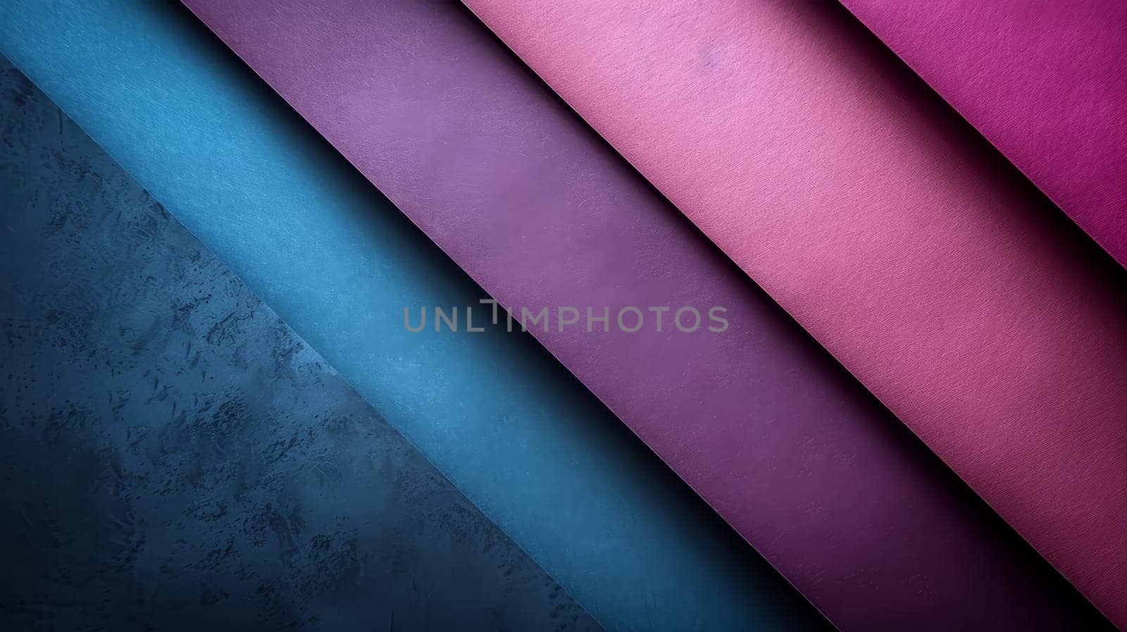Various sheets of textured paper in shades of blue, purple, and pink are arranged diagonally, showcasing their vibrant colors and patterns against a muted background, creating an artistic display.