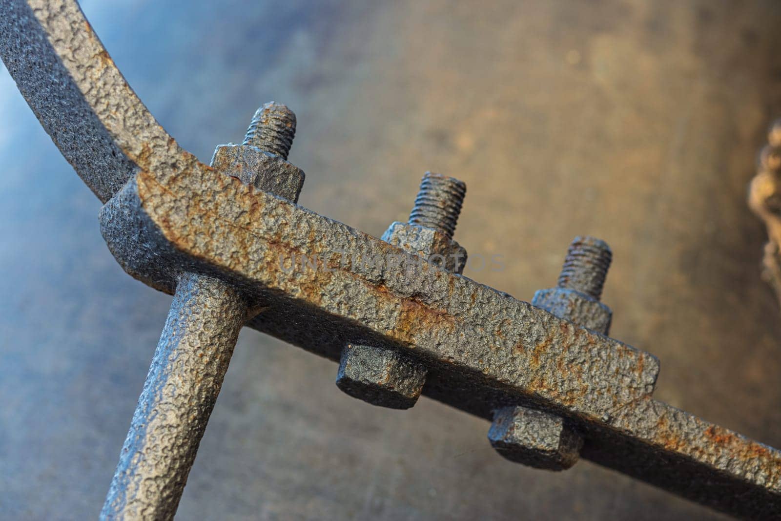 Close up view of a rusty metal church bell clapper, highlighting the craftsmanship and intricate details of welding and joining techniques