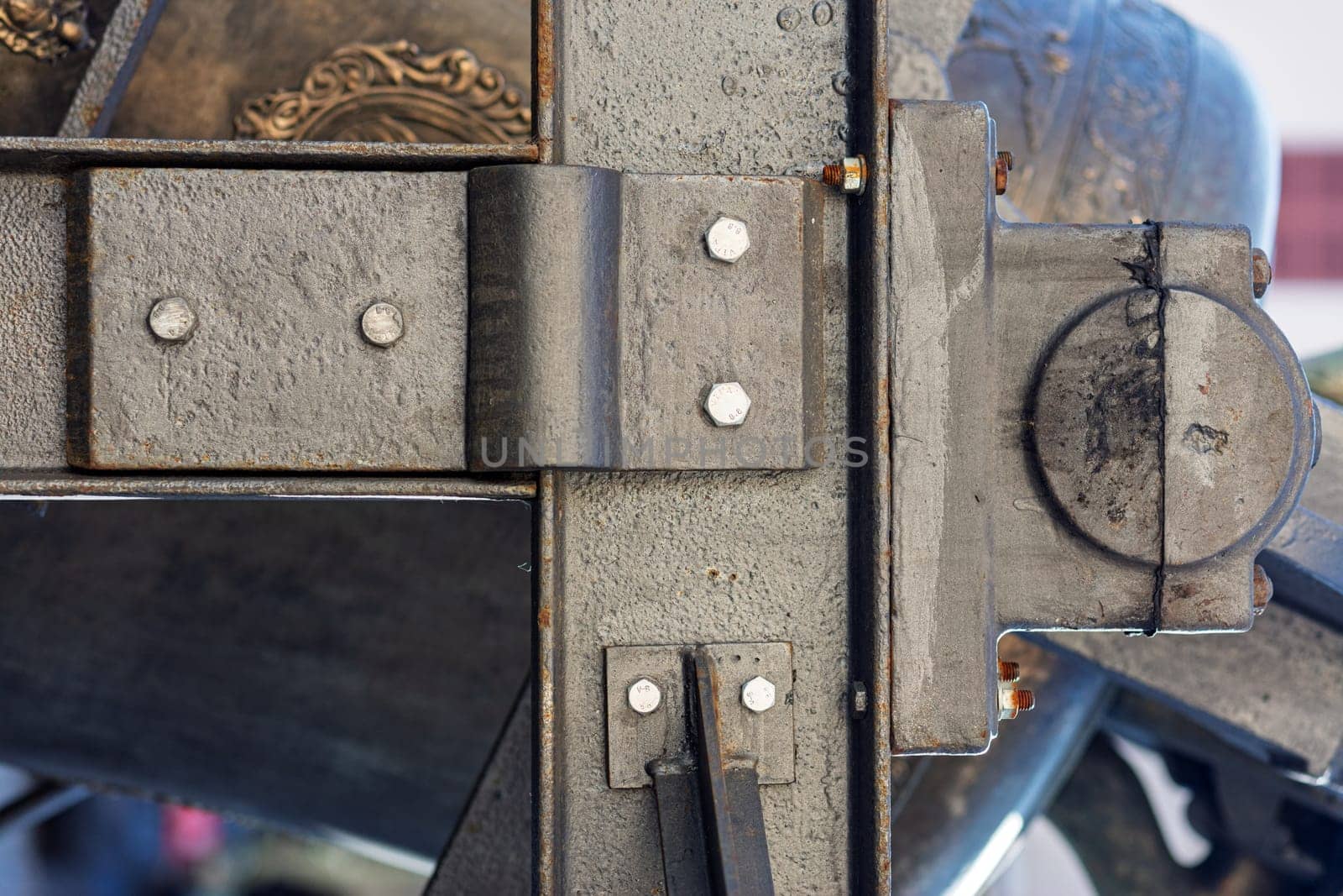 Close up of a metal church bell mounting system showing the craftsmanship and detailed welding used in its construction