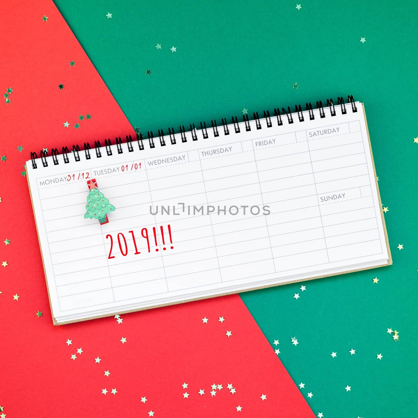 Creative New Year or Christmas timetable event planner mockup flat lay top view Xmas holiday celebration holiday schedule on red green paper background. Template mock up your text design 2019