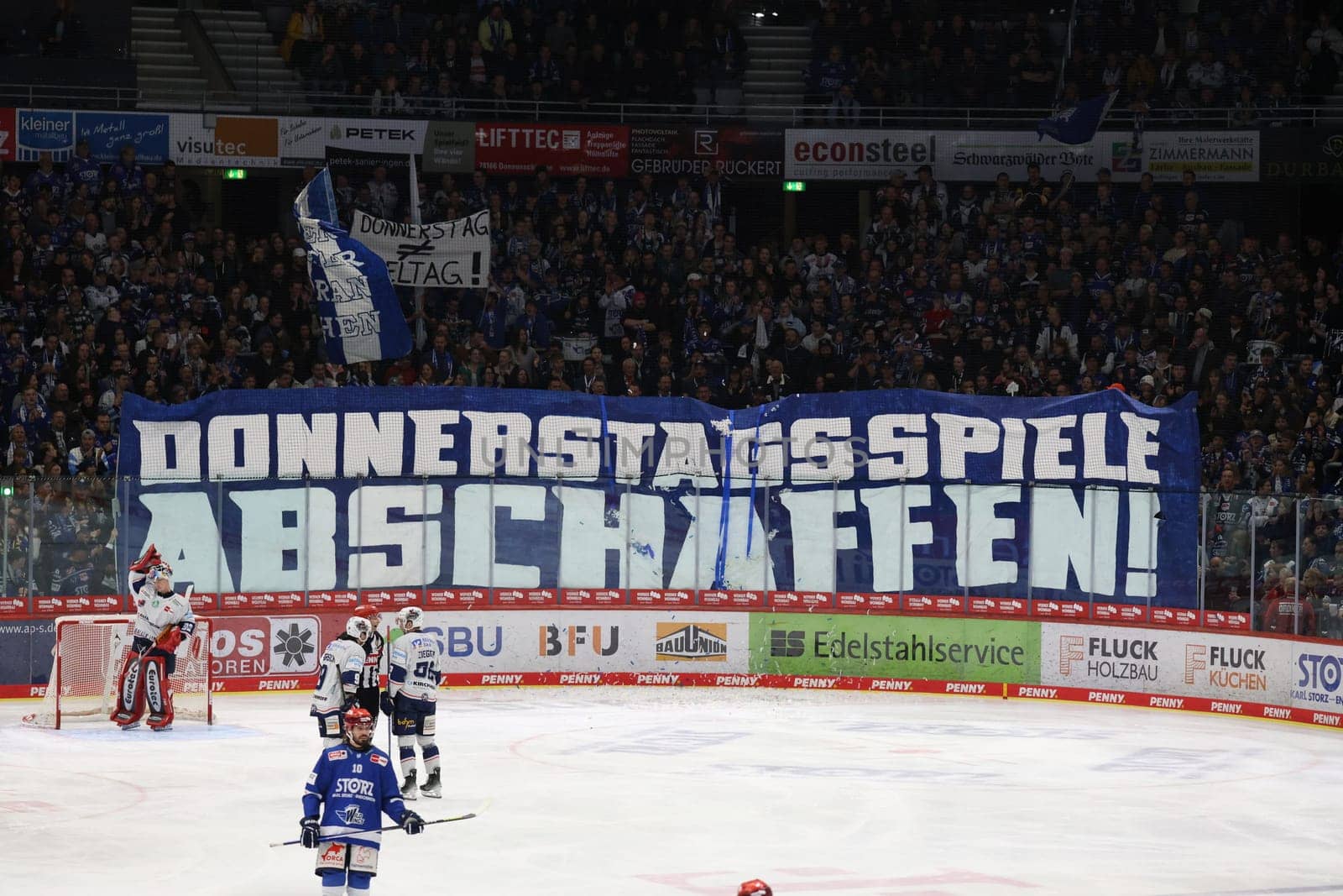 Abolishing Thursday games,is written on a banner of the Schwenninger fans,plus confetti rain on the ice brings a game interruption in the game of the DEL 24-25,10th Sptg.: Schwenninger Wild Wings vs Iserlohn Roosters