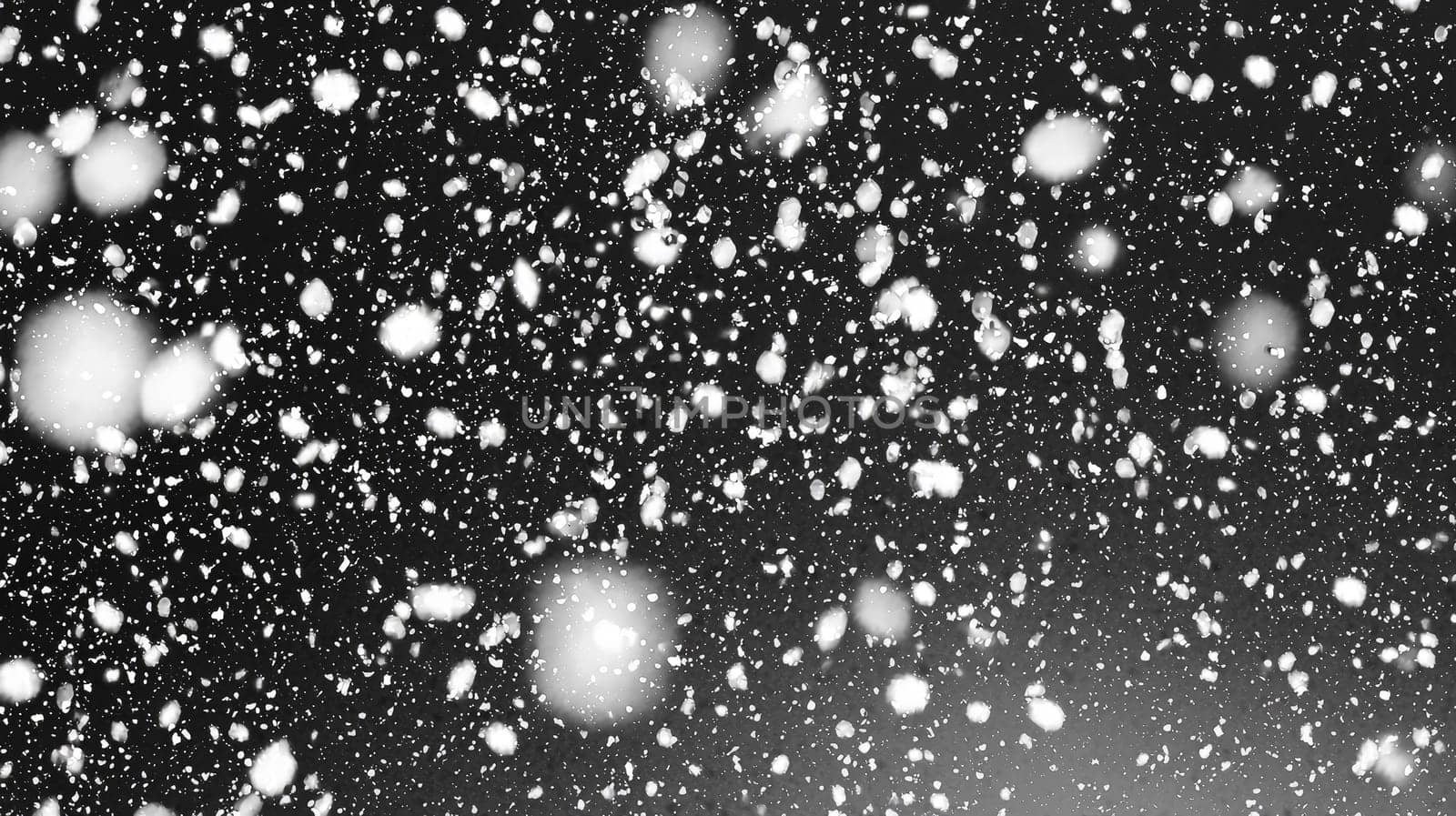 dramatic snowstorm overlay effect on a black background, showcasing swirling snowflakes and gusts of wind. This visual effect creates a cold, wintry atmosphere, perfect for enhancing images with a frosty, stormy feel. The stark contrast between the white snow and black backdrop adds intensity and depth to the scene.