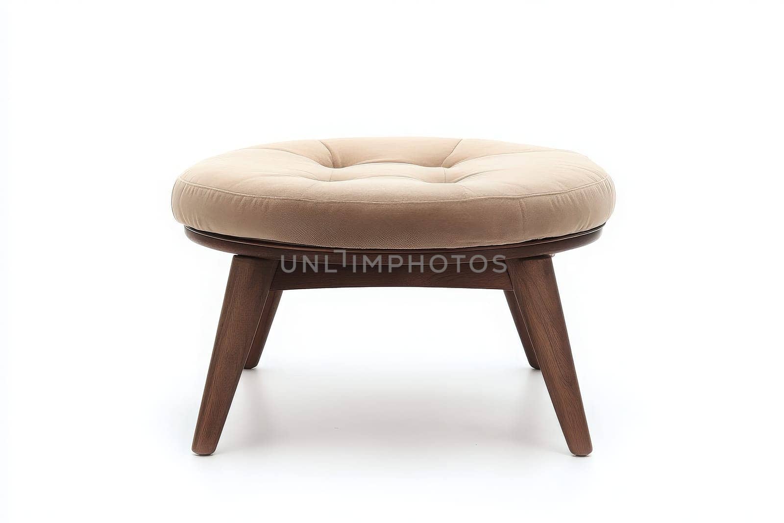 A cozy, tufted ottoman rests prominently in the middle of a minimalist space. Its soft fabric and wooden legs create a welcoming atmosphere for relaxation.
