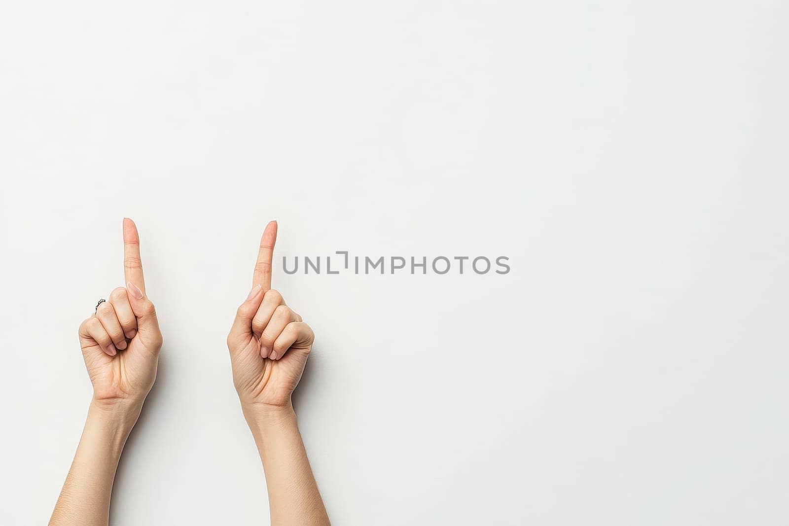 A pair of hands with crossed fingers expresses a gesture of hope and optimism. The hands are positioned against a clean, solid white backdrop, symbolizing positivity and good luck.