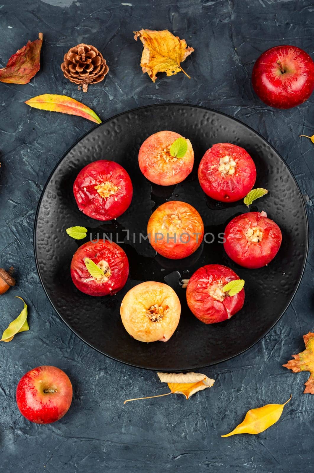 Tasty baked apples with nuts on a plate. Rustic style.