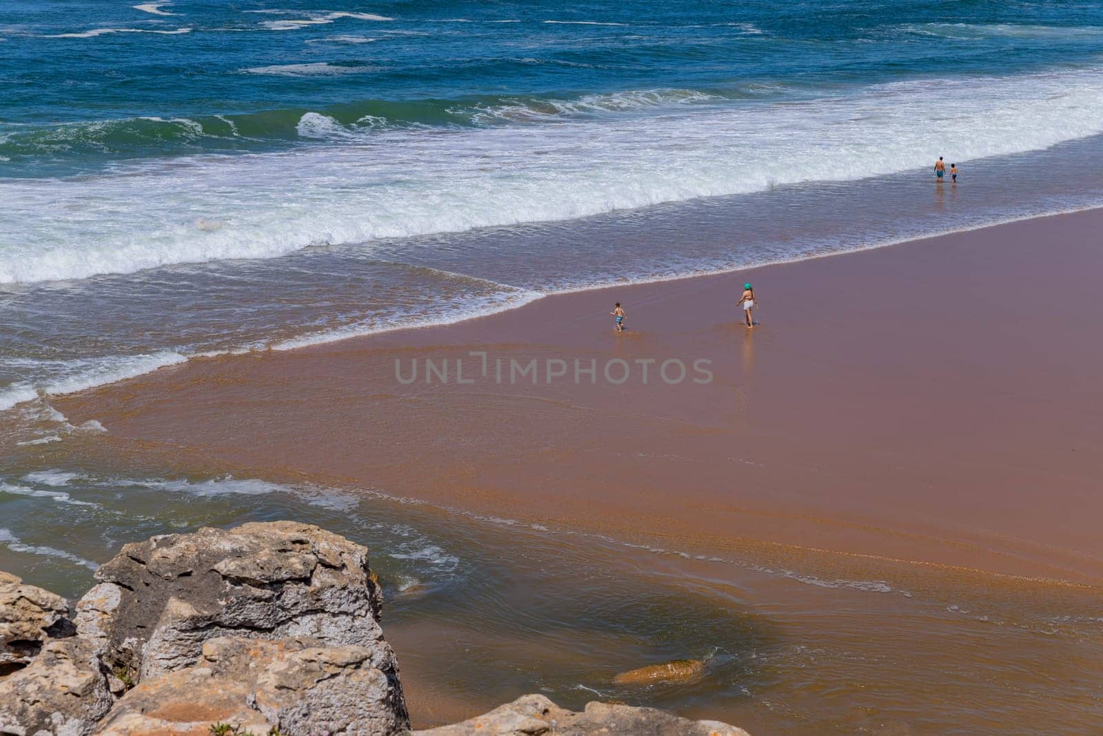 Sintra, Portugal: April 13, 2024: People at the beach of Foz do Lizandro, Ericeira, Portugal