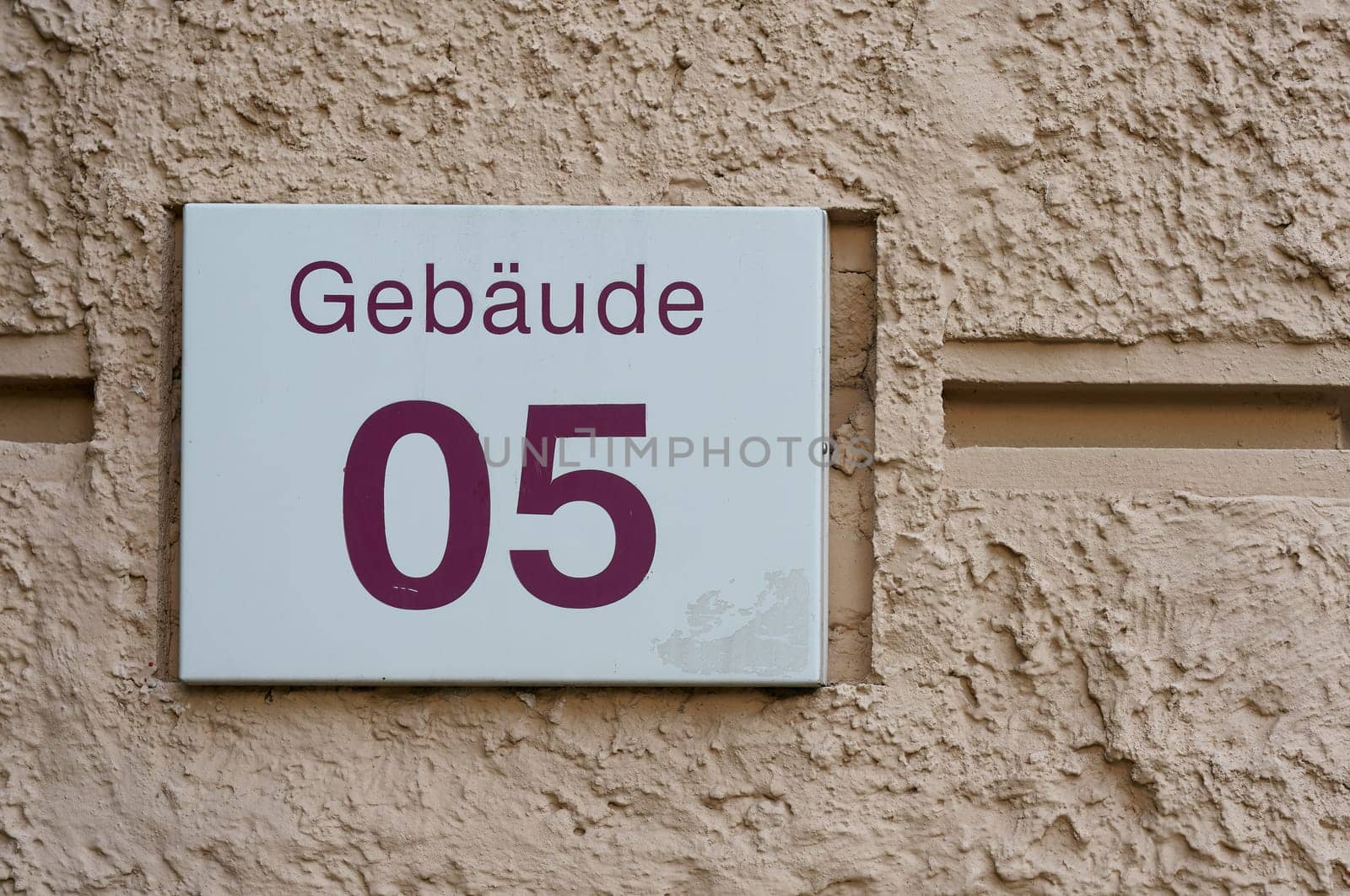 Sign with the German inscription Gebaude 05 on the facade of an administrative building. Translation: Building 05