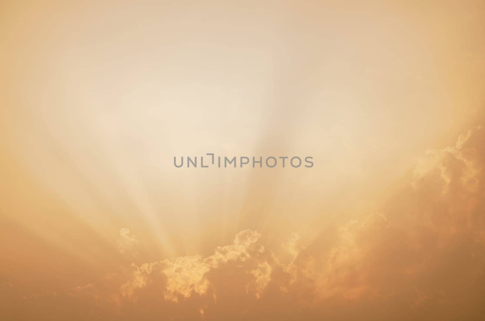 Dramatic orange sky with sunlit clouds creates ethereal abstract background. Tranquil beauty of sunset for inspirational imagery. Spiritual and nature-themed designs. Ideal for meditation apps.