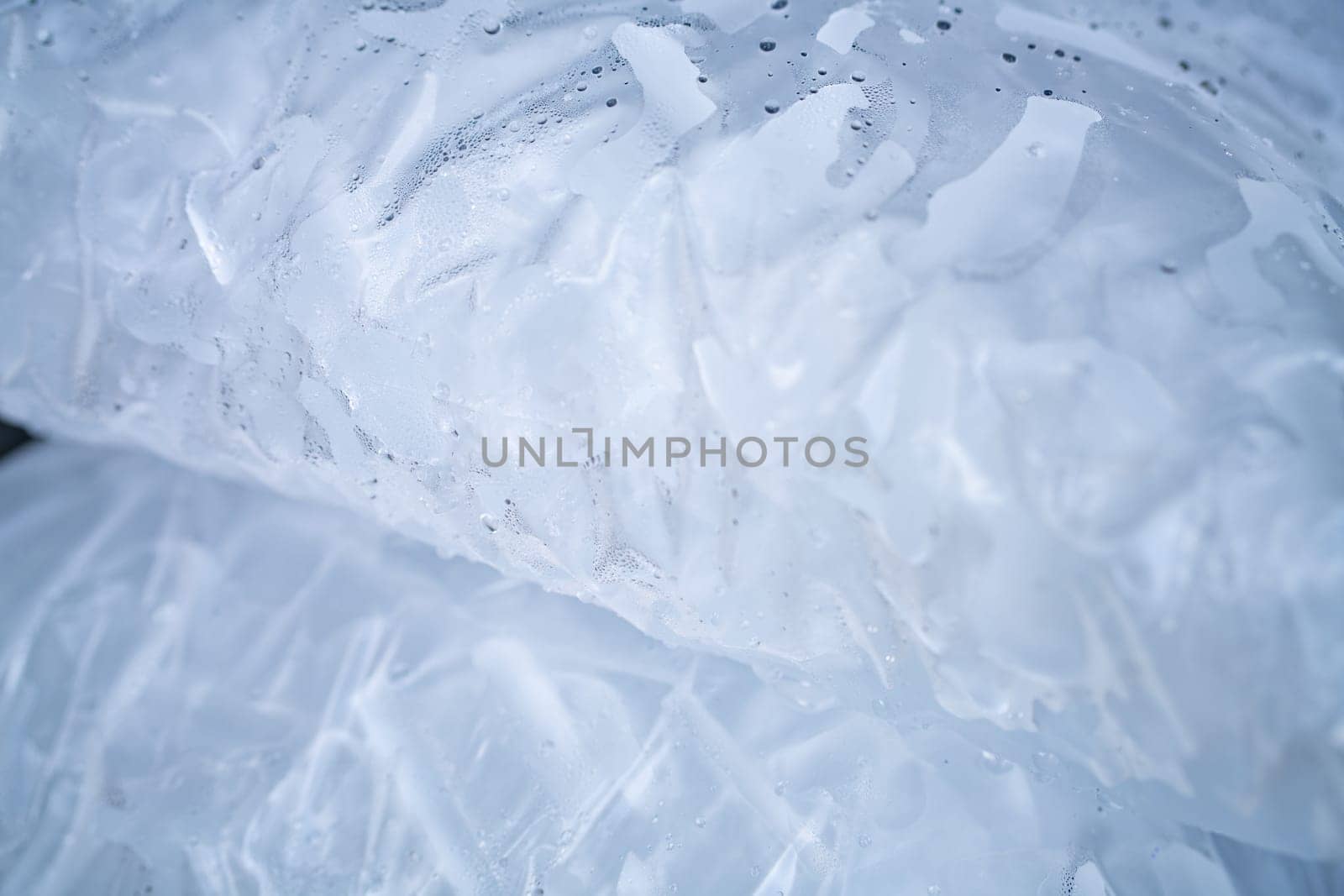 Closeup of tube ice inside a clear plastic bag. Convenient and lightweight packaging designed for easy transportation and storage. Hygiene and freshness for commercial and industrial applications.