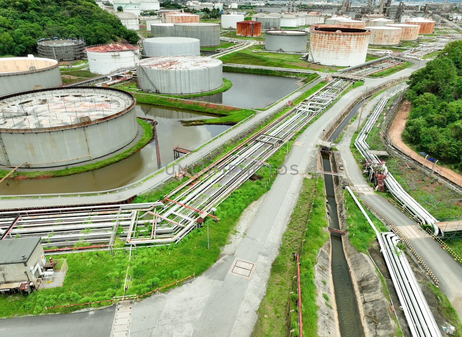 Aerial view of crude oil storage tank and pipeline system in a modern petrochemical plant. Efficient storage and transportation infrastructure in the oil and gas industry for safe fuel handling.