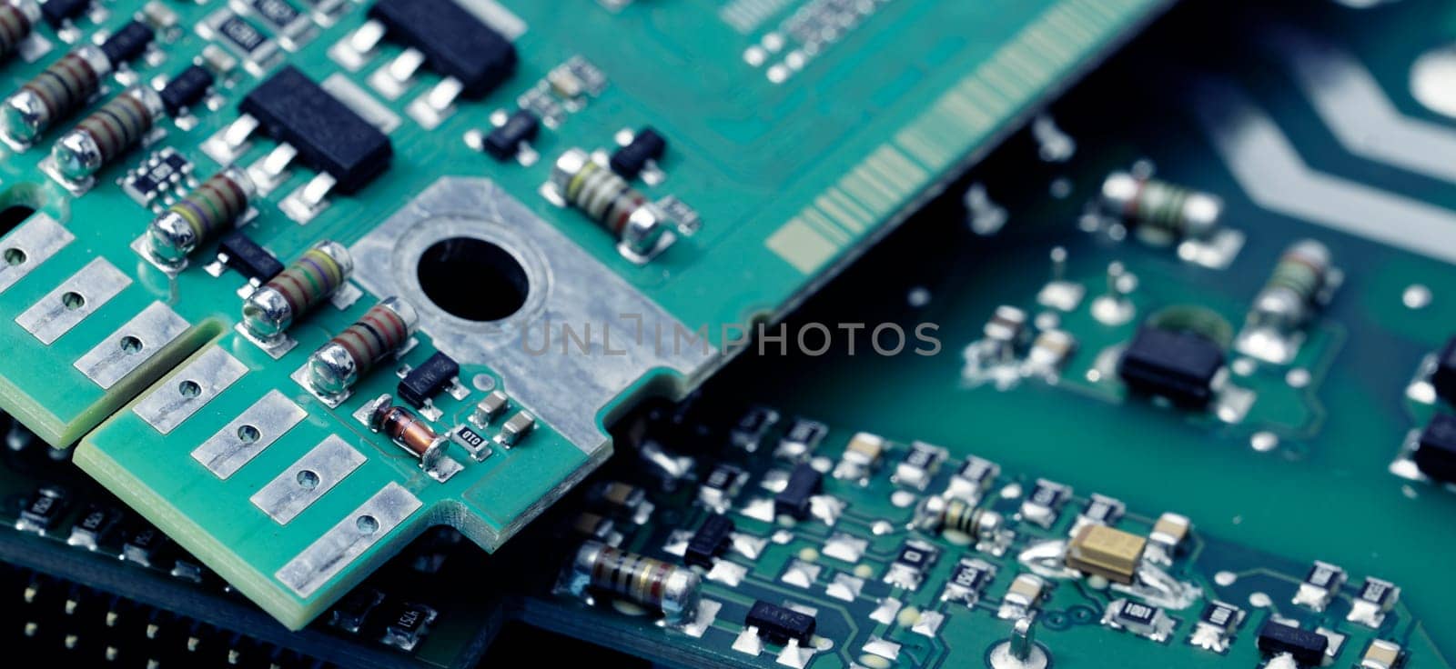 Close-up of a printed circuit board or PCB featuring wiring and microchip components. Advanced technology, precision engineering, and electronic hardware for modern devices and systems. PCB design.