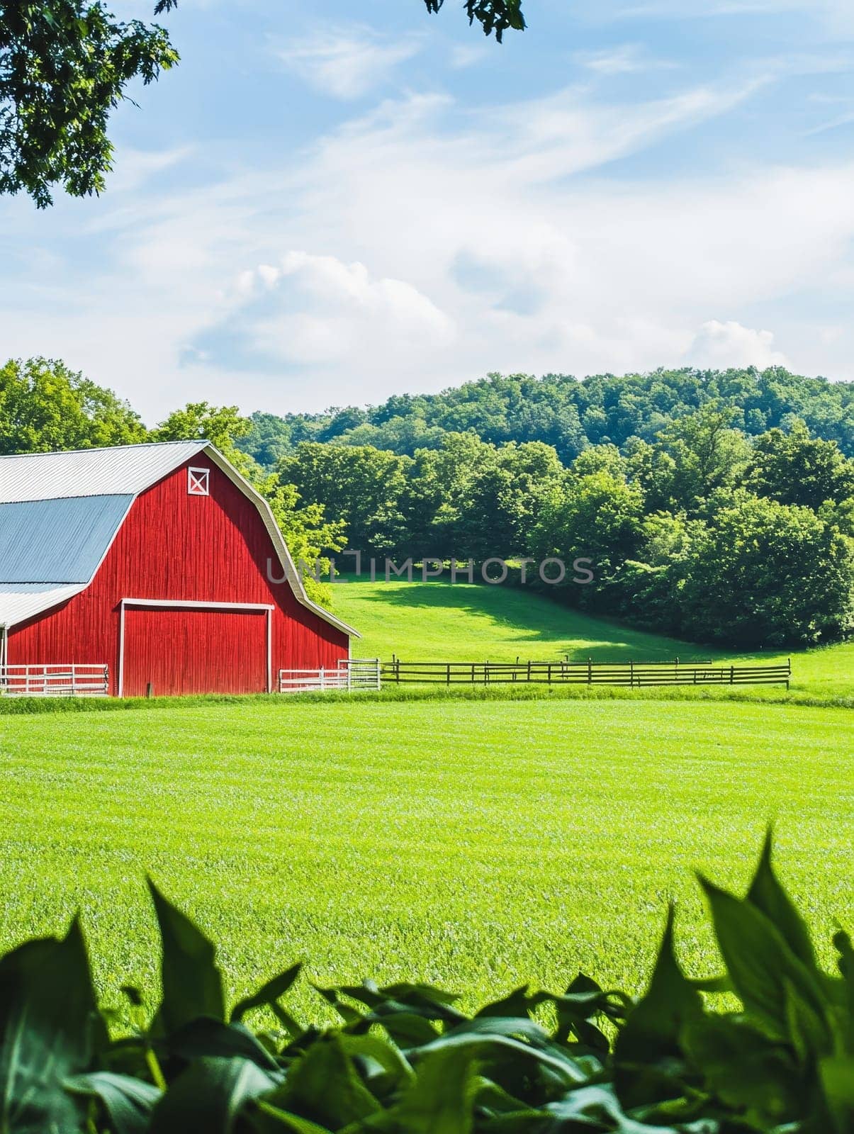 Iconic red barn with white trim amidst vibrant green fields and forests, epitomizing rural American landscape on a sunny summer day.