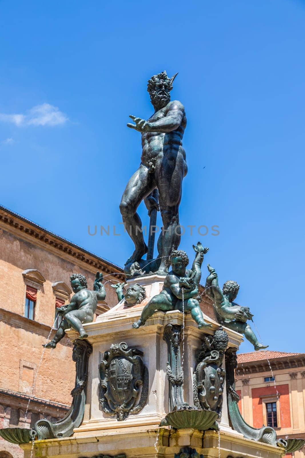 Bologna, Italy - 10 June 2024, the famous Neptune fountain located in Neptune Square. Bronze sculpture, blue sky