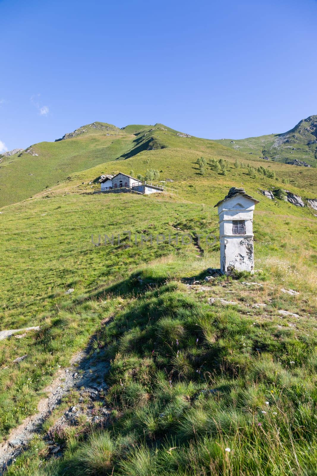 Panorama of Italian Alps with blue sky and clouds. Calm landscape, tranquil scenic view.
