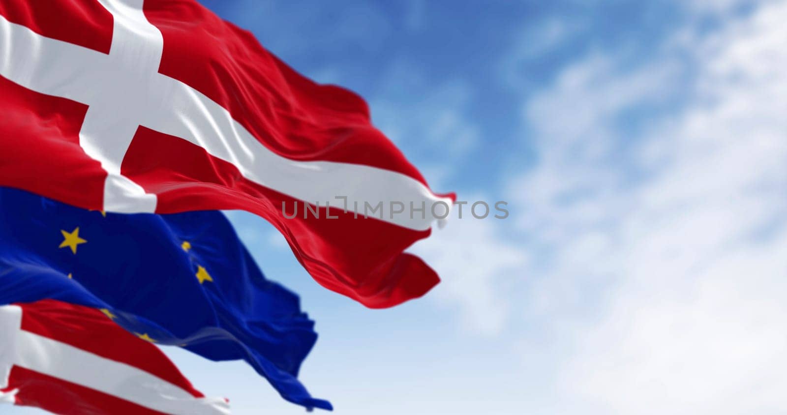 National flags of Denmark and of the European Union waving in the wind. 3D rendered illustration. Selective focus. Fluttering fabric. EU membership