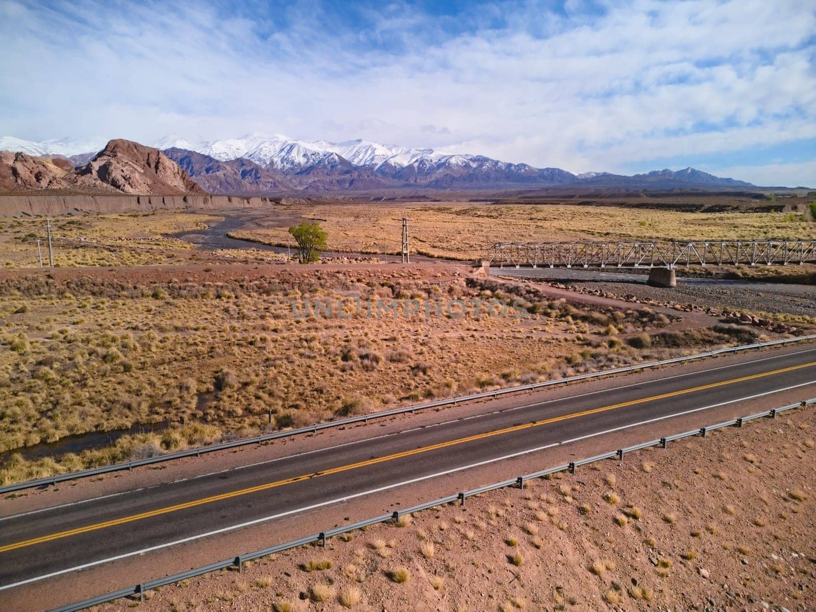 Asphalt road by the Andes mountains near Uspallata, Argentina.