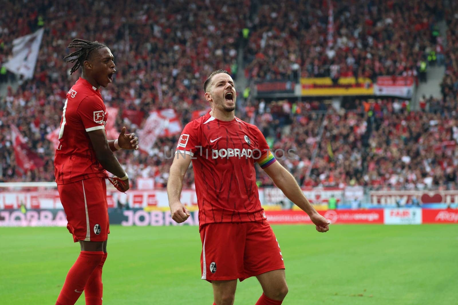 Christian Günter (SC Freiburg) celebrates his goal to make it 3-0 at half-time,Junior Adamu (SC Freiburg) celebrates with him in the match of the 1st FBL: 24-25: 1st FBL: 24-25: 7th Sptg. SC Freiburg - FC Augsburg  DFL REGULATIONS PROHIBIT ANY USE OF PHOTOGRAPHS AS IMAGE SEQUENCES AND/OR QUASI-VIDEONann  Photo: Joachim Hahne/johapress