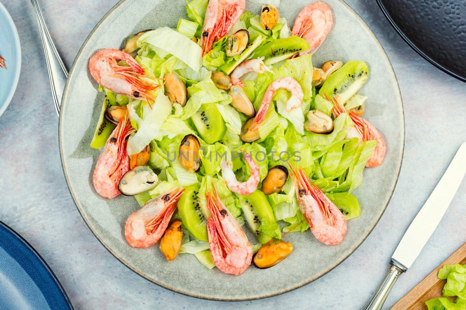 Homemade seafood salad with mussels and shrimps. Food background