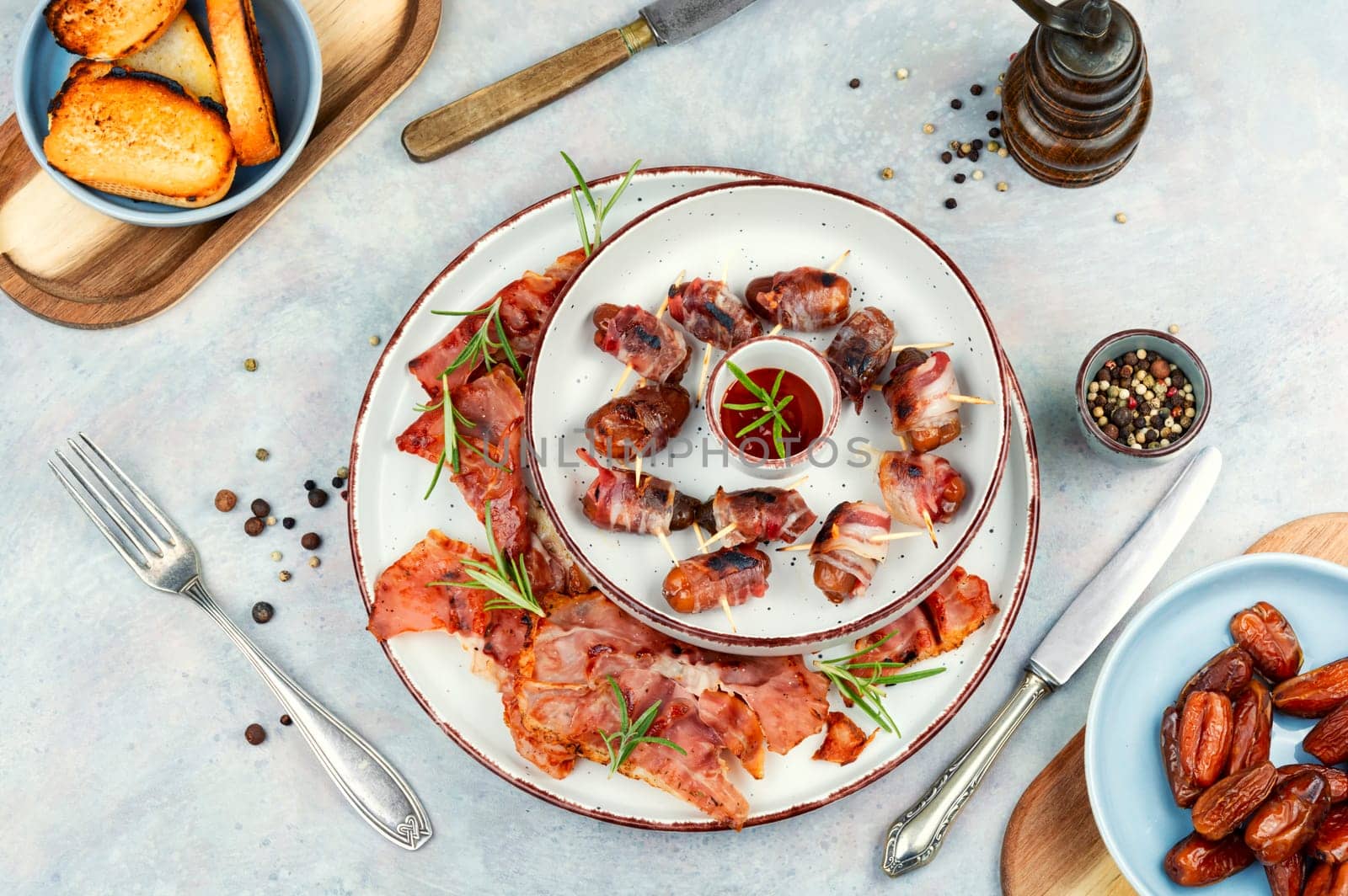 Appetizer delicacy dates wrapped in fried bacon.