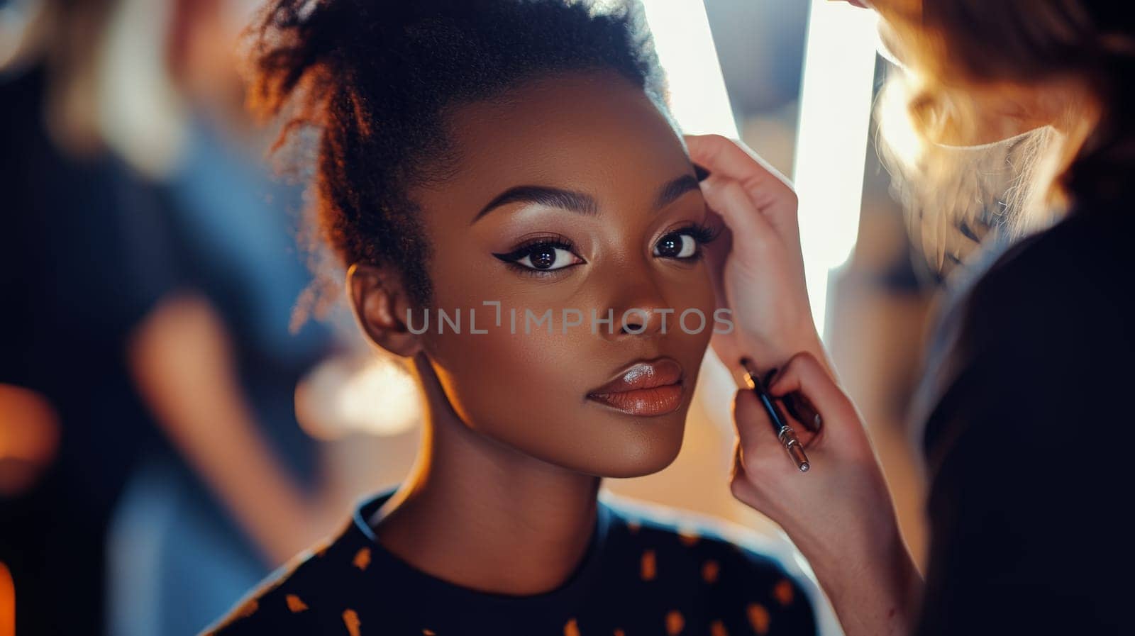 Professional makeup artist applying finishing touches to a model's face during a fashion photoshoot, showcasing behind the scenes beauty preparation.