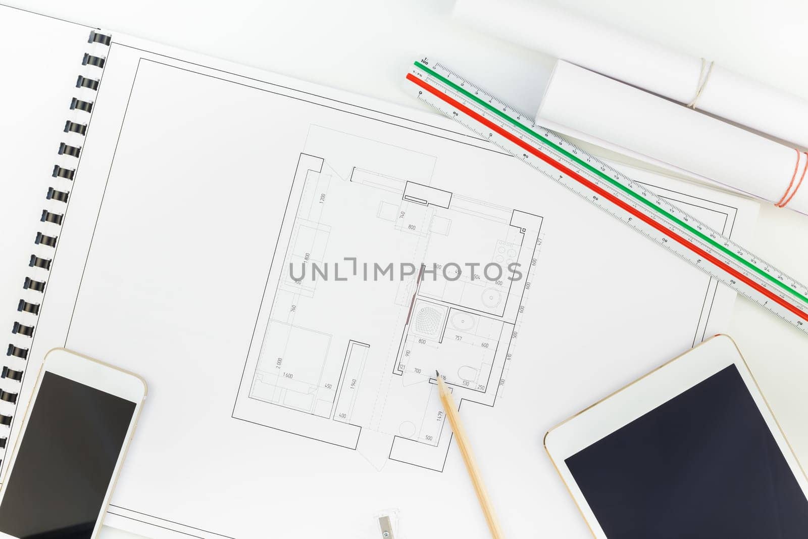 Creative flat lay overhead top view blueprints architectural flat project plan and office supplies on decorator white table workspace with swatches tools and equipment background copy space concept