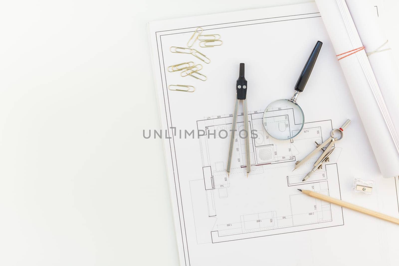 Creative flat lay overhead top view blueprints architectural flat project plan and office supplies on decorator white table workspace with swatches tools and equipment background copy space concept