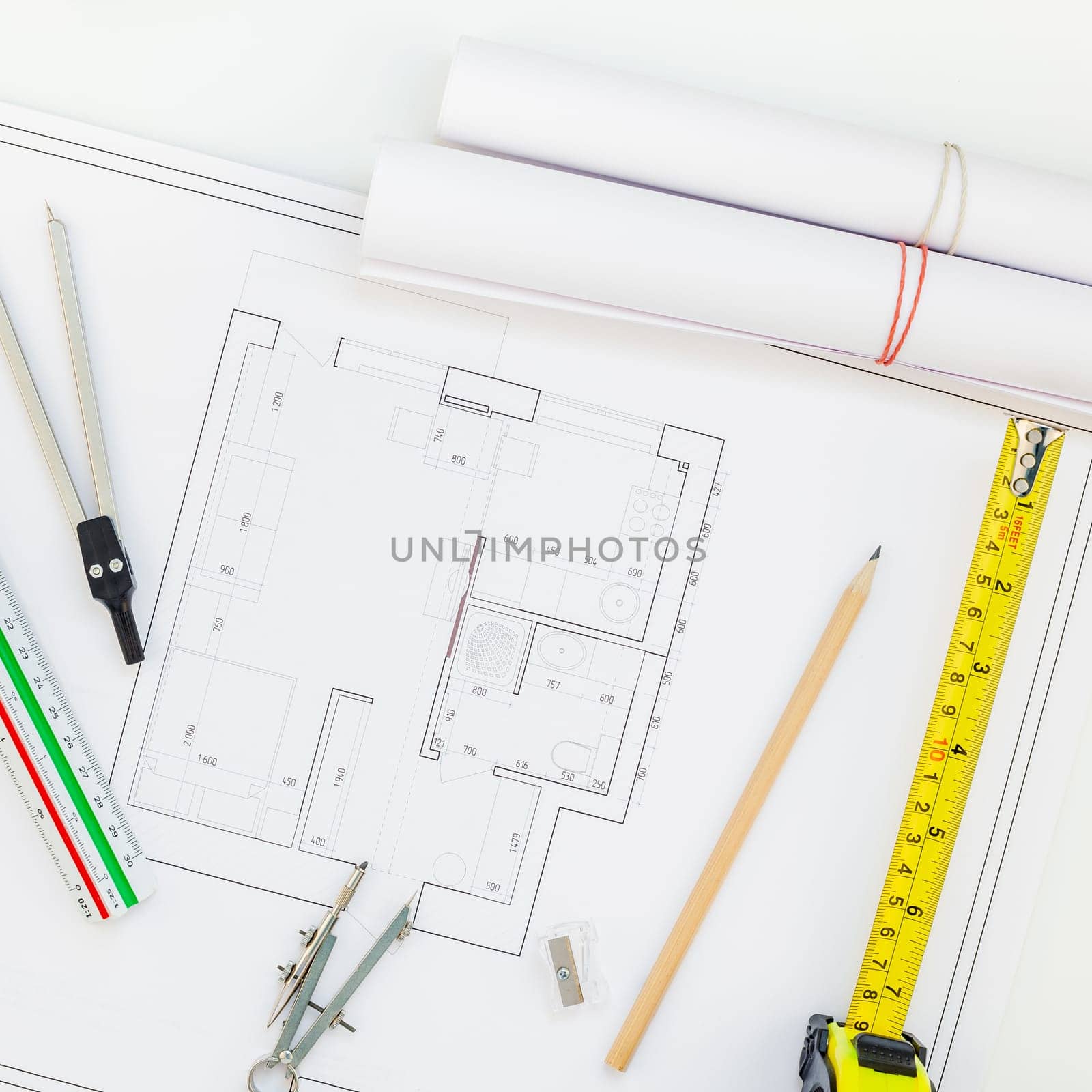 Creative flat lay overhead top view blueprints architectural flat project plan and office supplies on decorator square white table workspace swatches tools and equipment background copy space concept