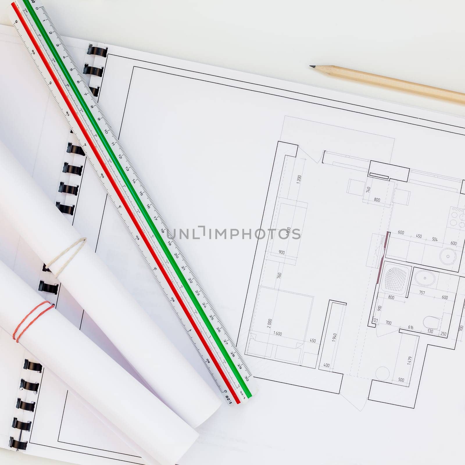 Creative flat lay overhead top view blueprints architectural flat project plan and office supplies on decorator square white table workspace swatches tools and equipment background copy space concept