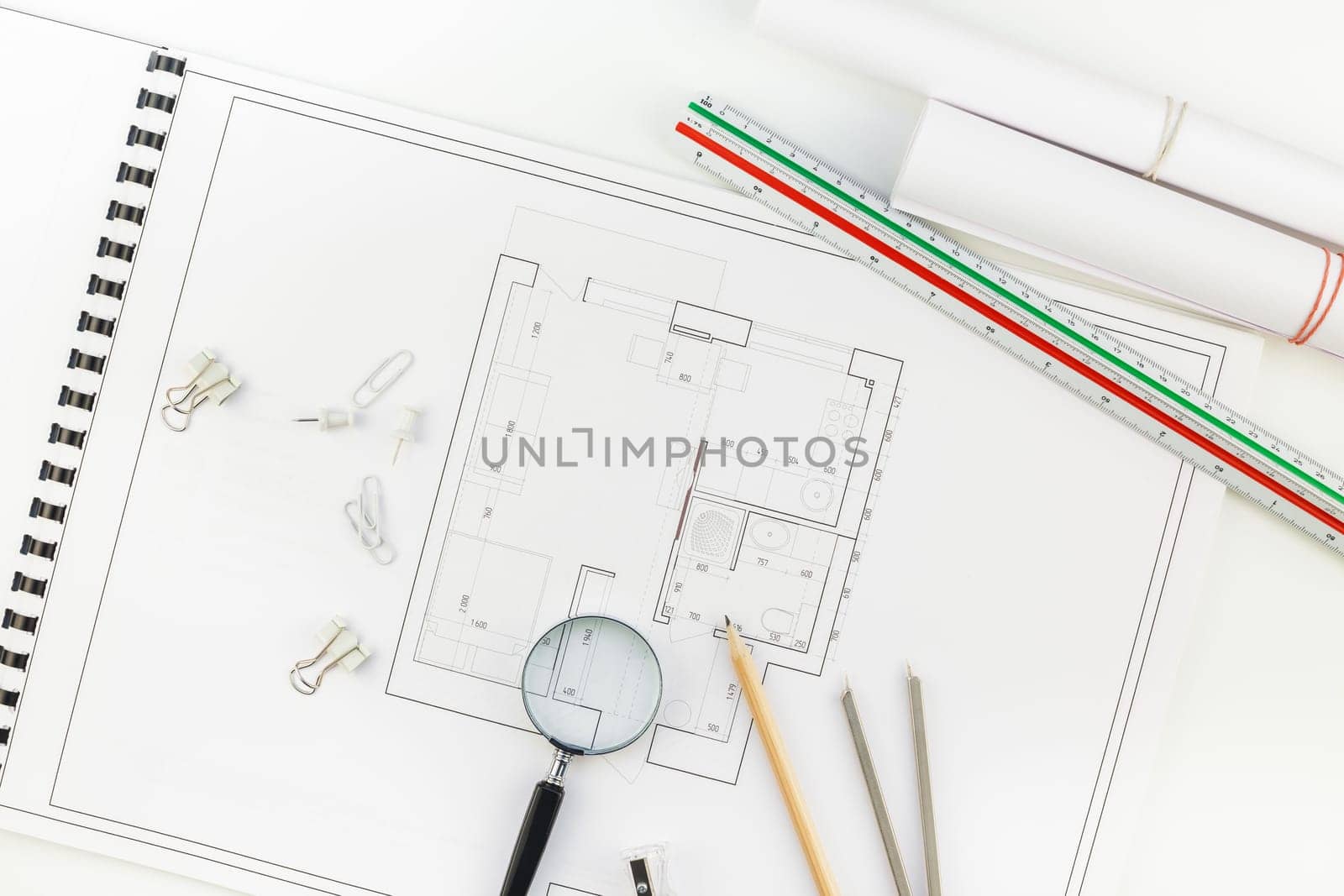 Creative flat lay overhead top view blueprints architectural flat project plan and office supplies on decorator white table workspace with swatches tools and equipment background copy space concept