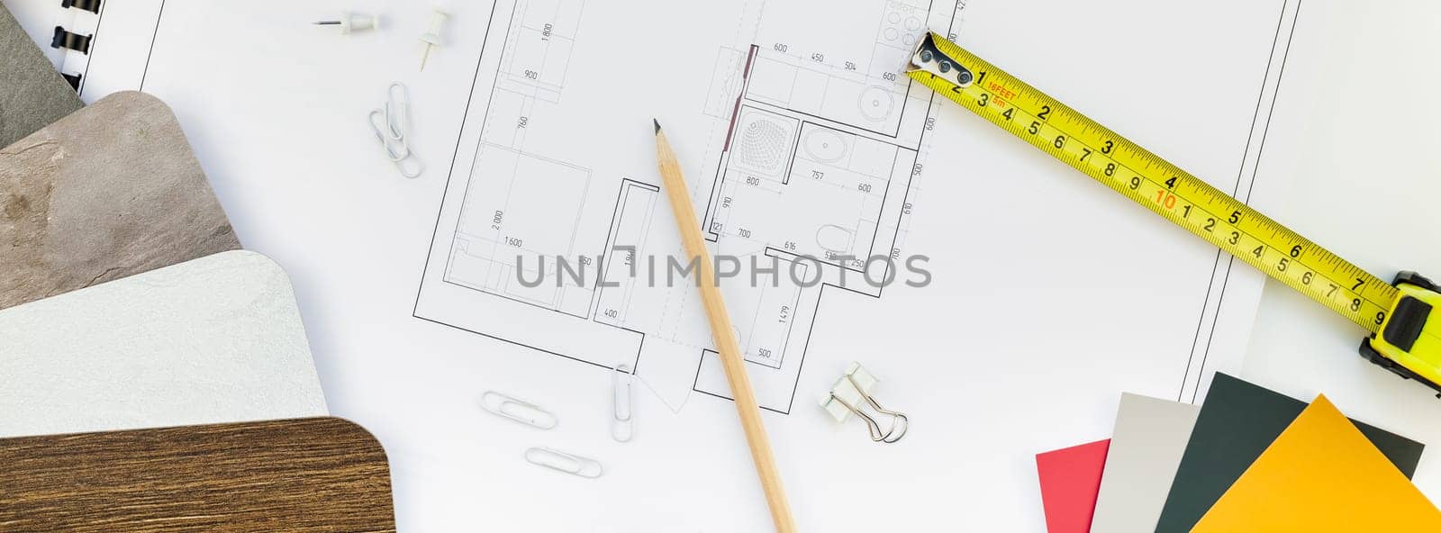 Creative flat lay long wide banner top view blueprints architectural flat project plan and office supplies on decorator white table workspace swatches tools equipment background copy space concept