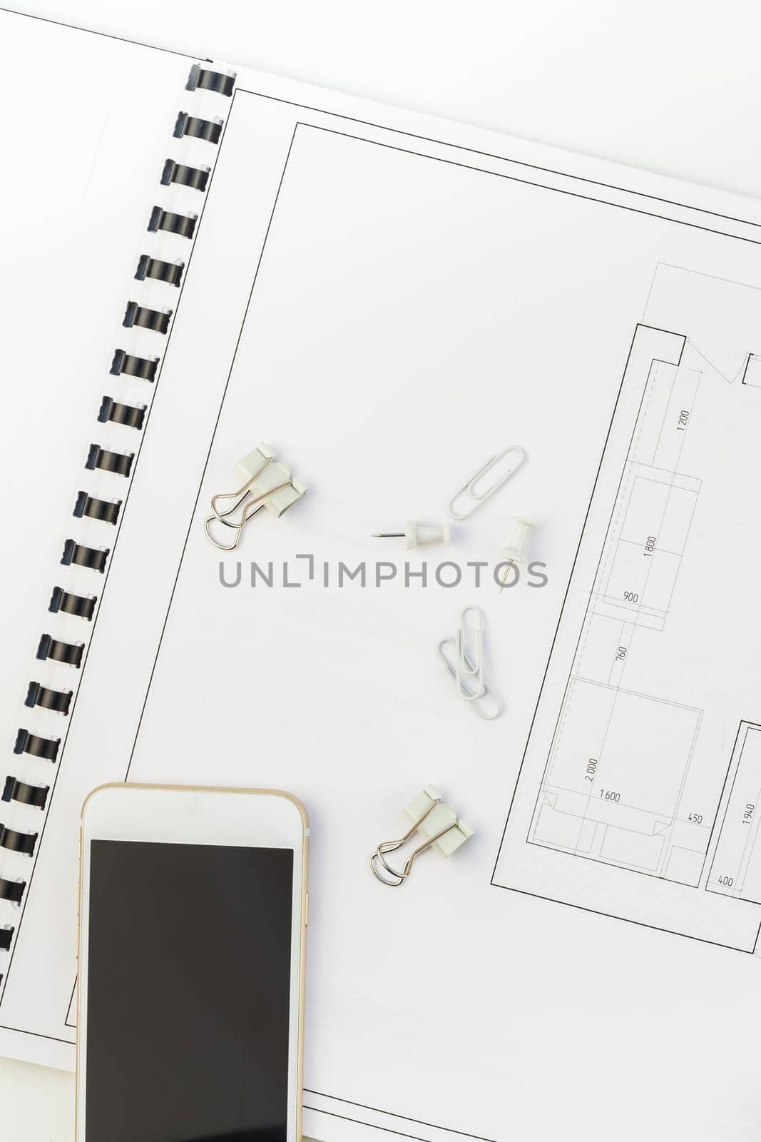 Creative flat lay overhead top view blueprints architectural flat project plan and office supplies on decorator white table workspace with swatches tools and equipment background copy space concept