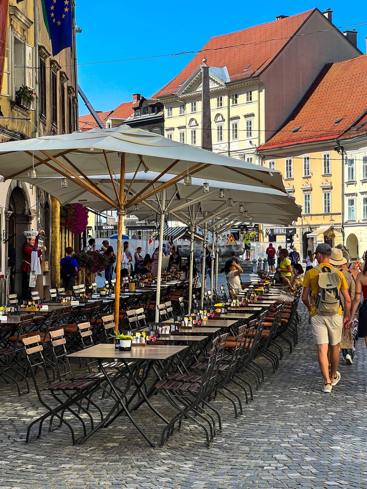 Ljubljana, Slovenia - AuguLjubljana, Slovenia - August 15, 2023: People at outdoor restaurant gardens on the street, Old Townst 15, 2023: People at outdoor restaurant gardens on the street, Old Town. High quality photo