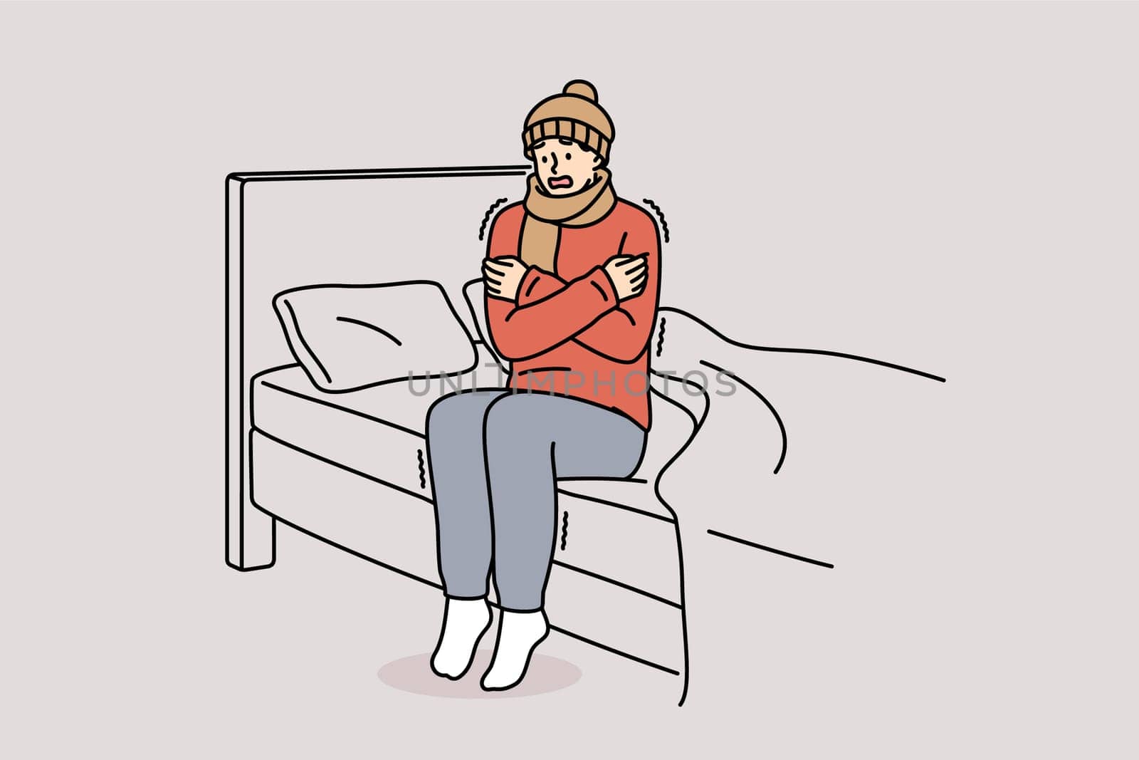 Freezing man is shaking sitting on bed and feeling chills and cold, dressed in hat and scarf. Freezing guy suffers due to lack of central heating system and poor immunity, located in bedroom