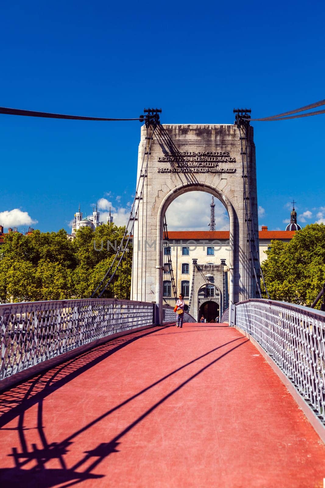 FRANCE, LYON - AUGUST 22: People are walking along Old Passerelle du College bridge over Rhone river in Lyon, France on August 22, 2014