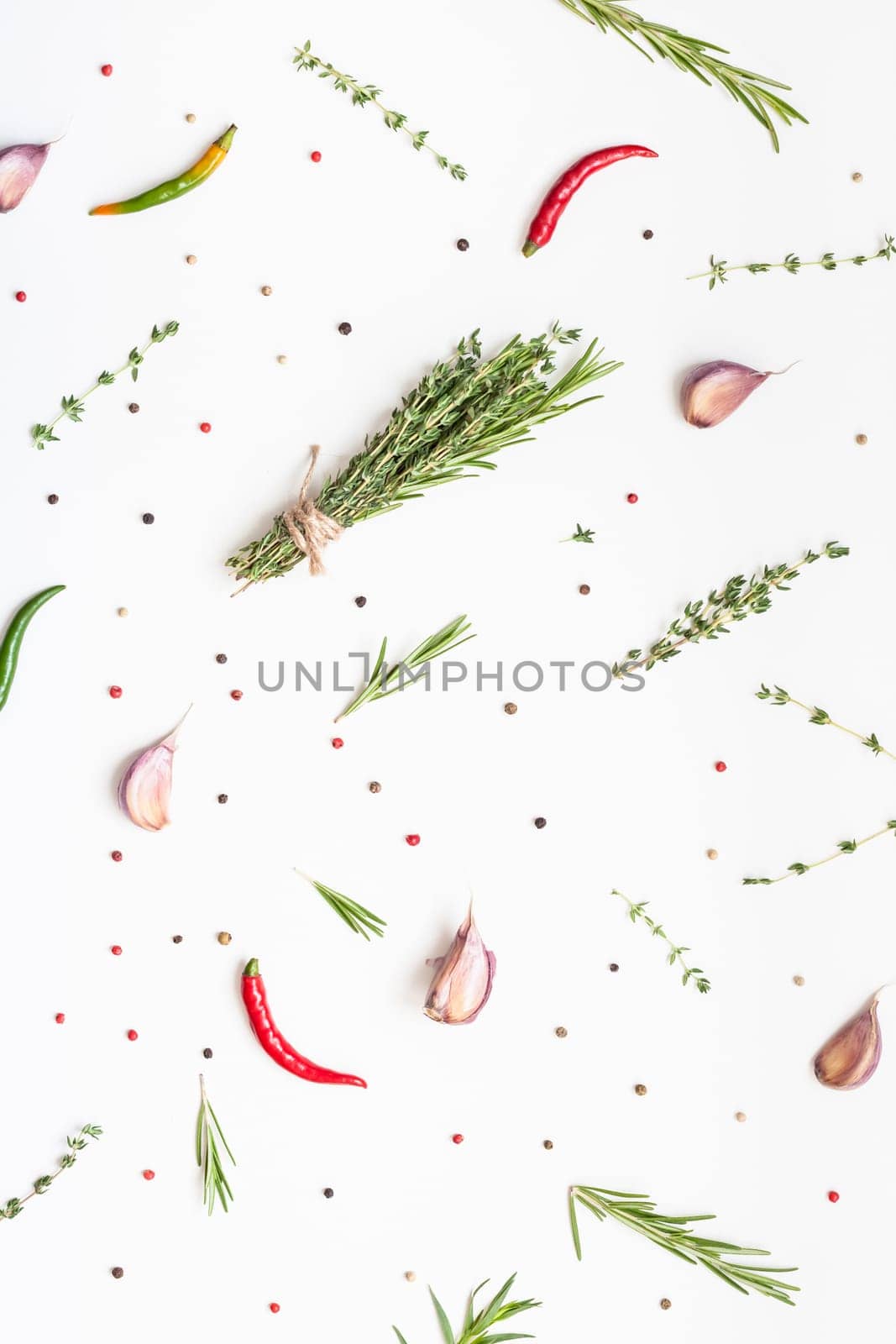 Flat lay overhead top view of greens herbs and spices on white background with copy space. Menu frame design food pattern background with cooking ingredients