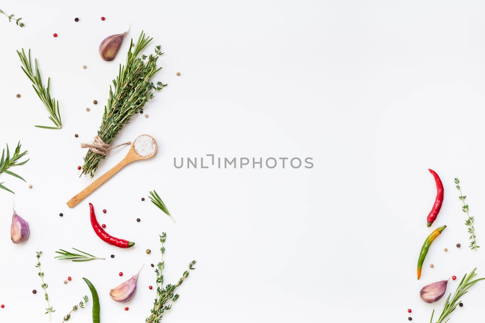 Flat lay overhead top view of greens herbs and spices on white background with copy space. Menu frame design food pattern background with cooking ingredients