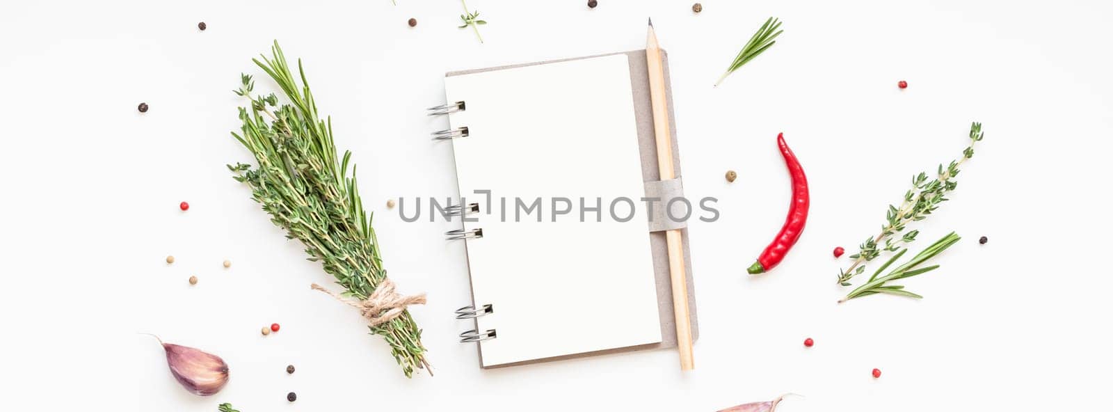 Flat lay overhead view blank notebook pages mockup text space invitation card on white background with greens herbs and spices. Menu or recipe book or food blog design with cooking ingredients