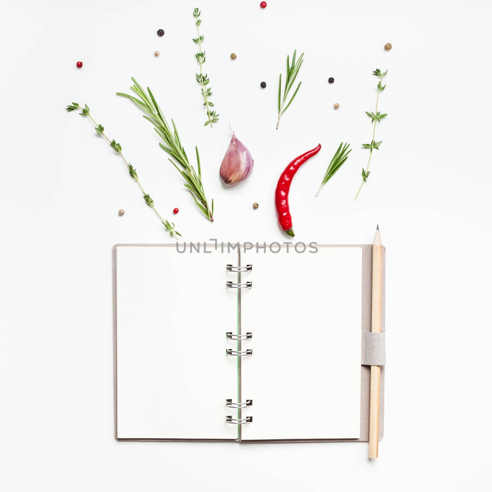 Flat lay overhead view blank notebook pages mockup text space invitation card on white background with greens herbs and spices. Menu or recipe book or food blog design with cooking ingredients