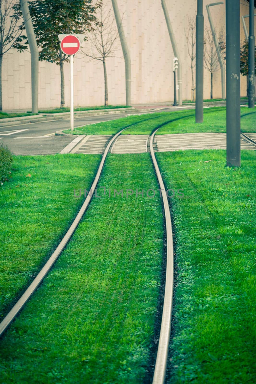 Tram rails covered with green grass lawn in Bilbao, Spain