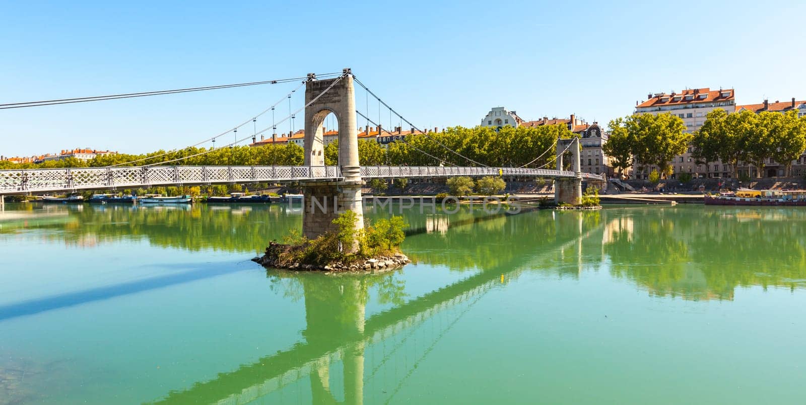 Old Passerelle du College bridge over Rhone river in Lyon, France. Summer day