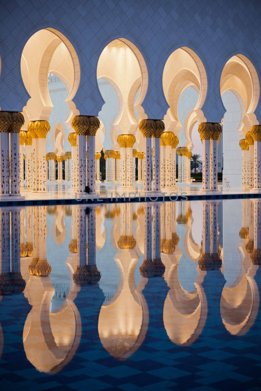 Beautiful gallery of famous Sheikh Zayed White Mosque in Abu Dhabi, UAE. Reflections at sunset