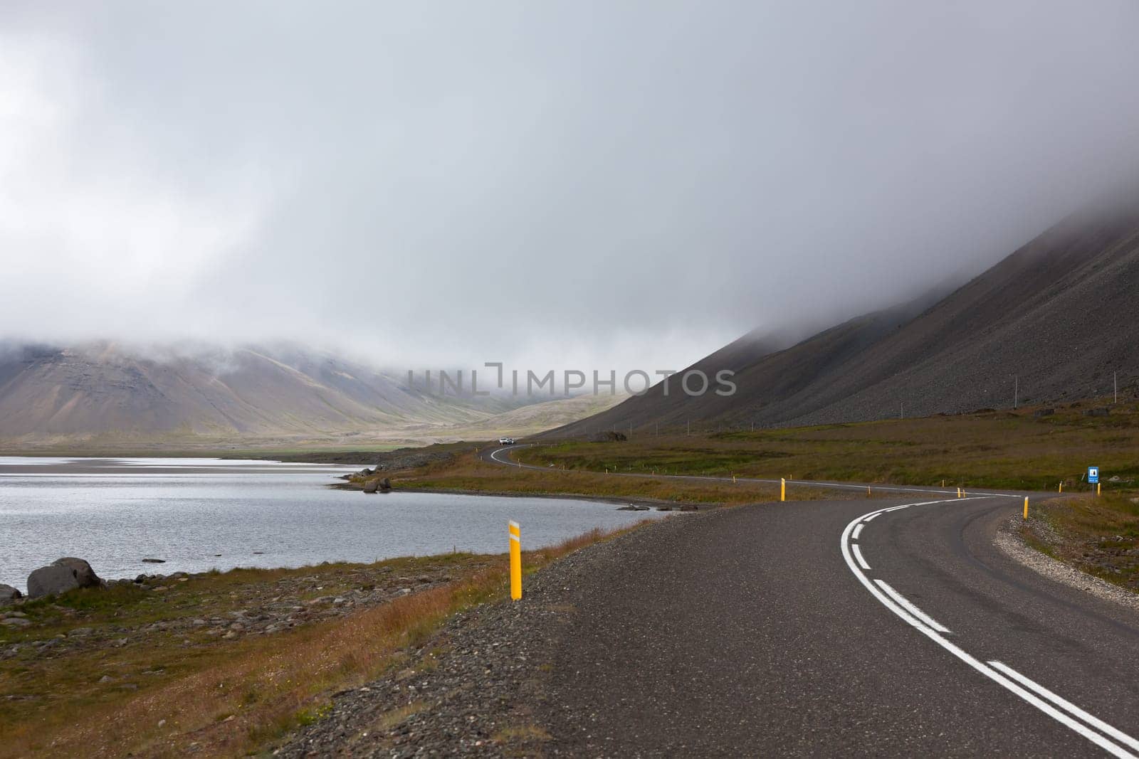 Highway through Iceland landscape at overcast day. Horizontal shot