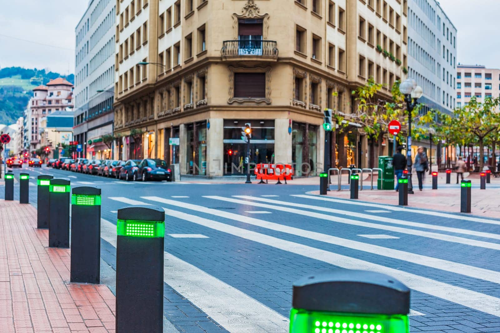 City centre in Bilbao, Spain with modern traffic lights posts on pedestrian crossing